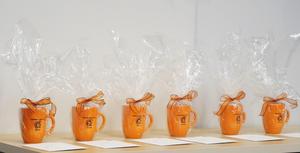 TK mugs filled with treats given for board appreciation.