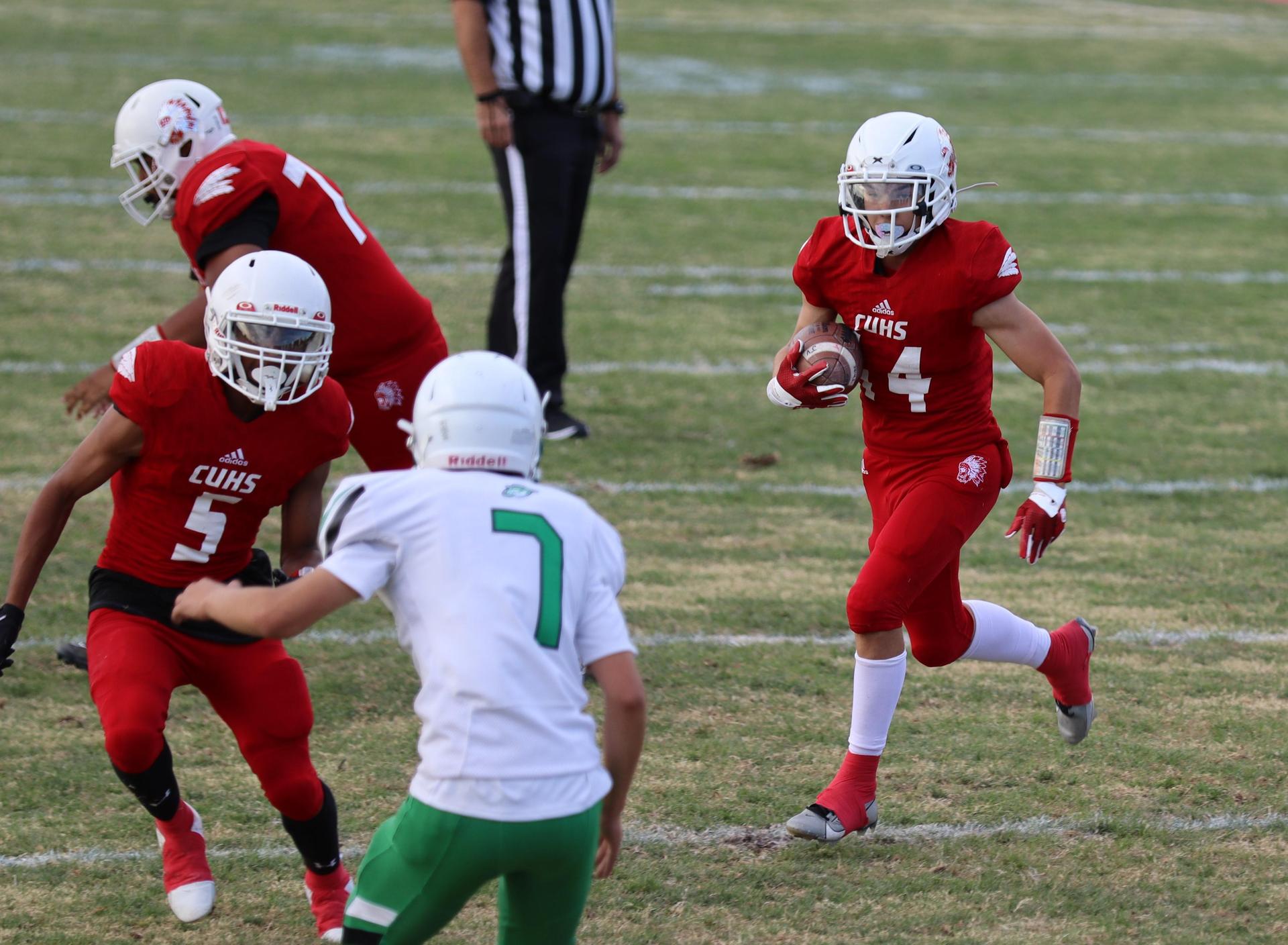  junior varsity football players in action against riverdale