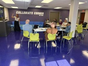 Staff listen to a presentation on Empowering Minds in the new Collegiate Corner