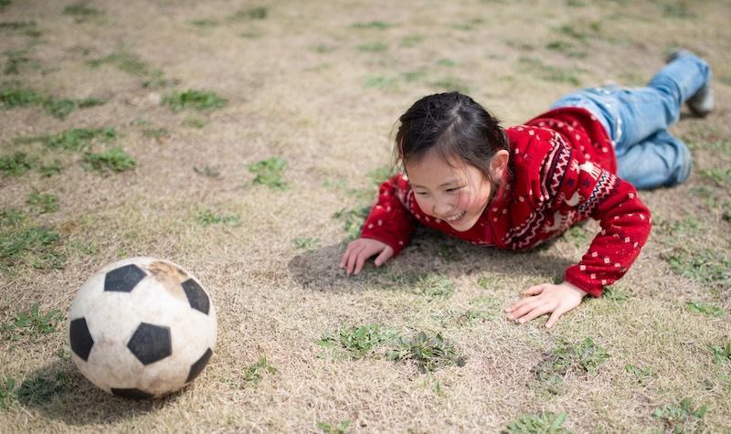 Child stumbles playing soccer
