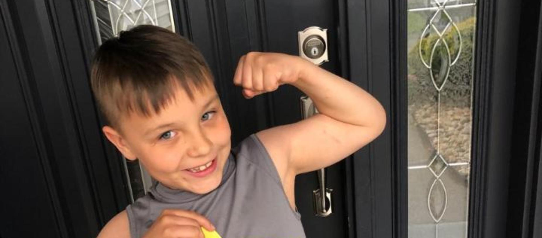 Boy flexing his muscles