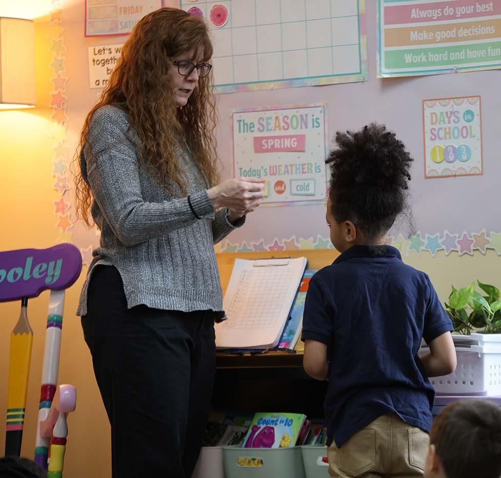 Student and teacher working together in classroom