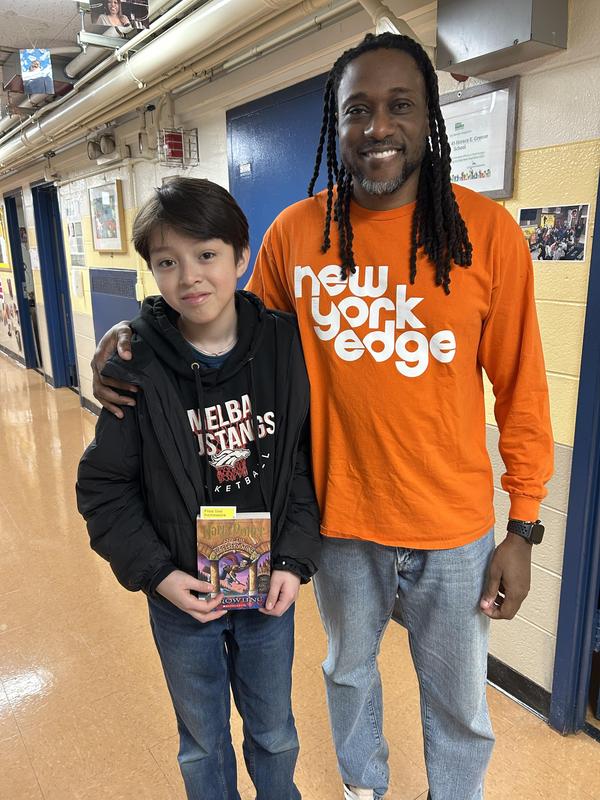 Student with one of the Harry Potter Books and Mr. Thompson
