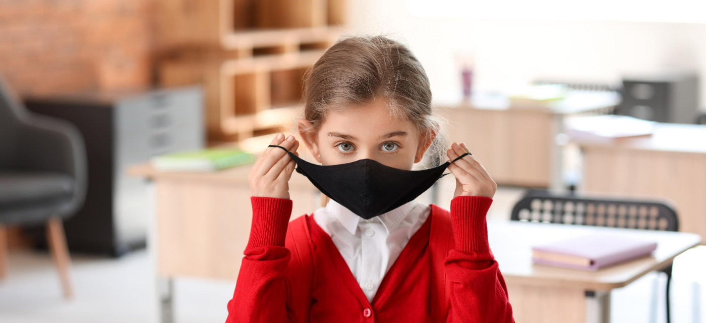 girl putting on mask