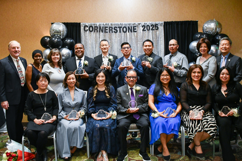 12 Cornerstone employees pose for a photo with the Board of Trustees.