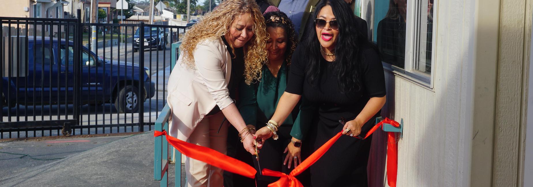 Women cutting giant ribbon
