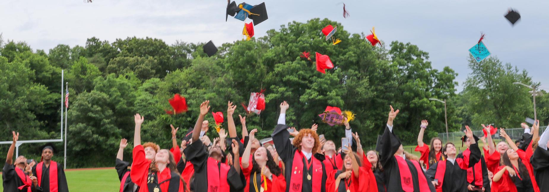 Graduation caps being tossed in the air
