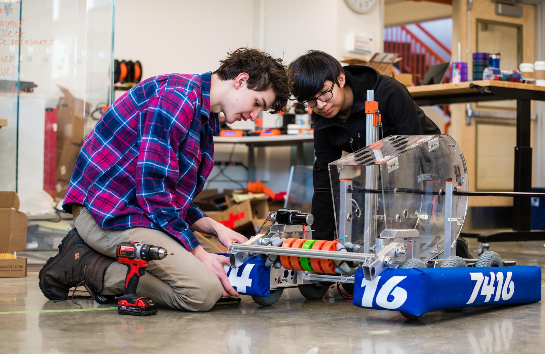 Two students working on a robot in the I^3 Lab.