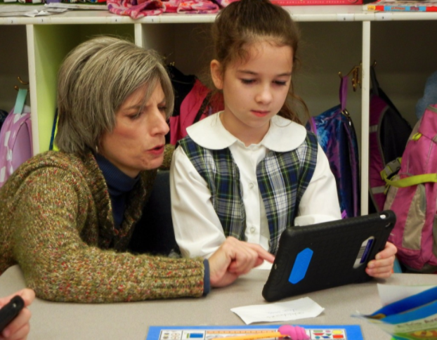 Teacher and student using iPad