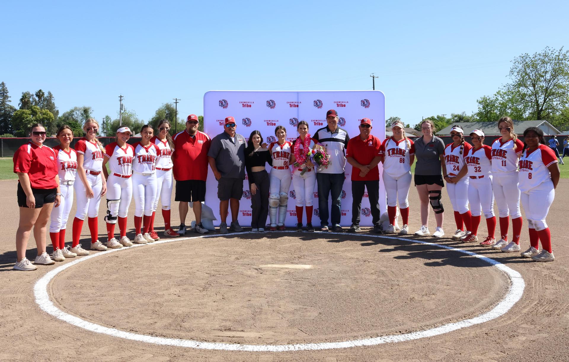 Seniors Posing With Teammates, Coaches, And Family