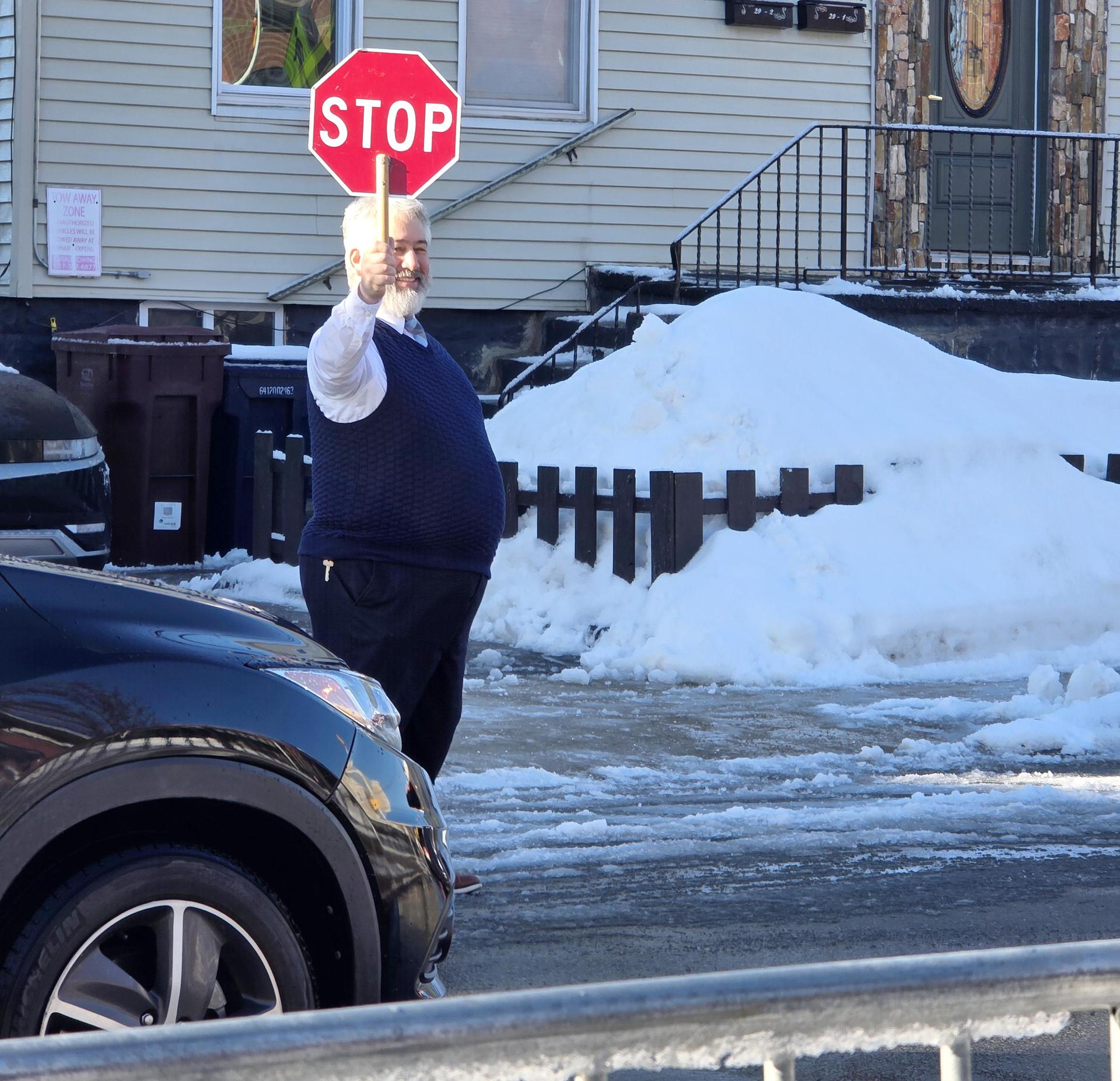 Man holding up a stop sigjn