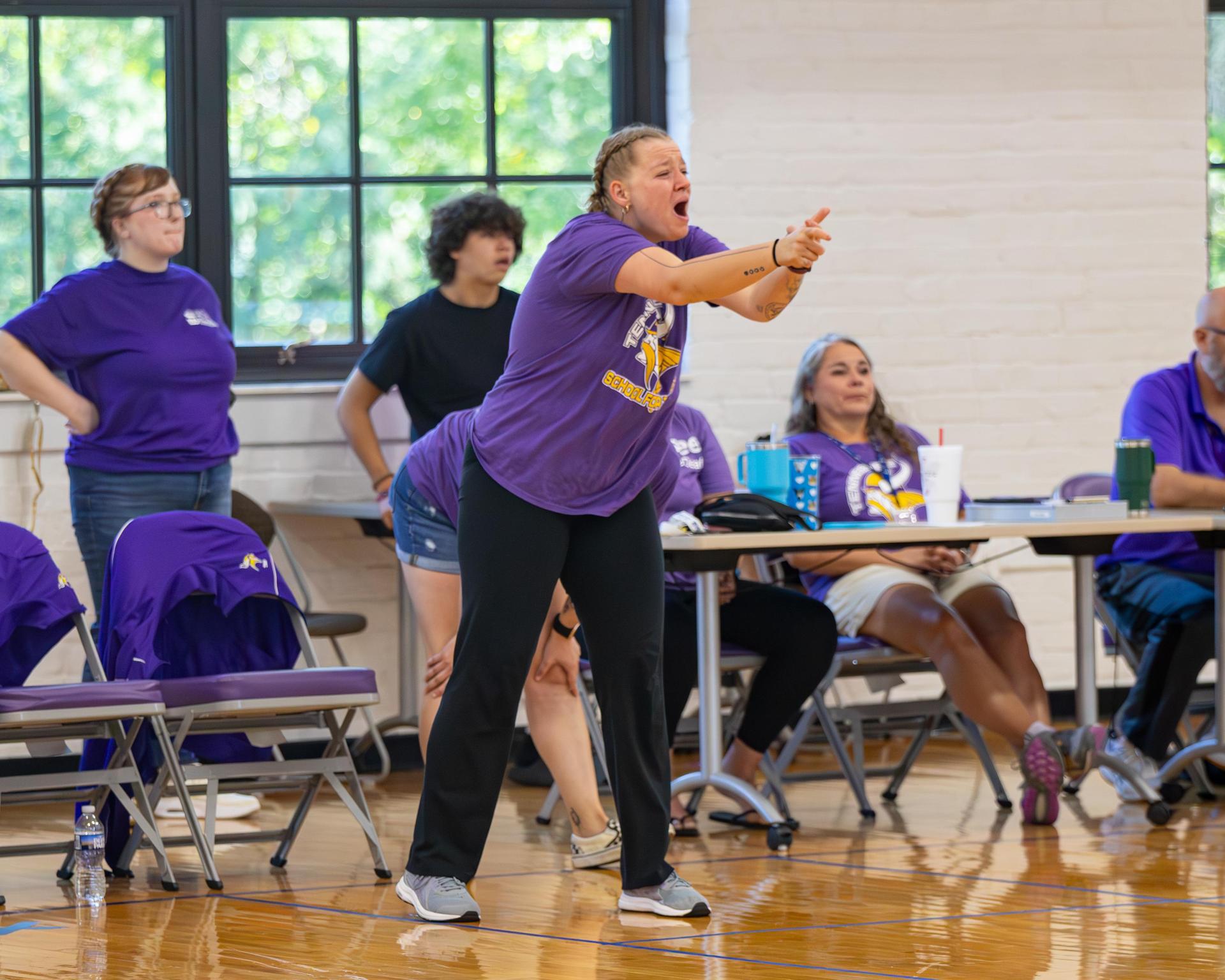 Coach passionately instructing a group of players in a gym setting.