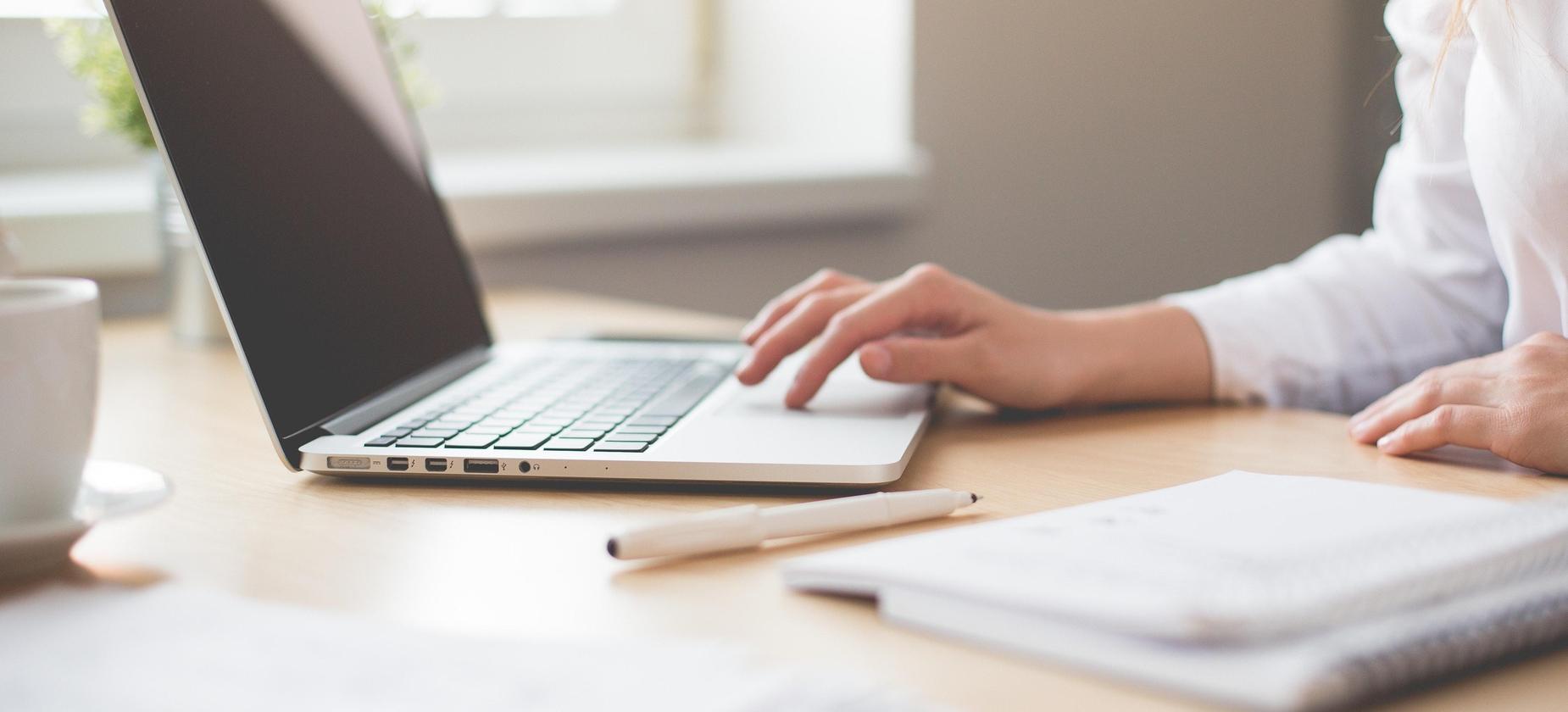 Woman typing on a laptop