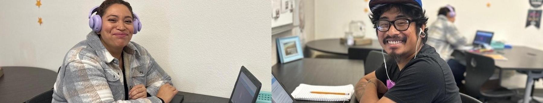 Two smiling people at laptops in a study space, engaged in work.
