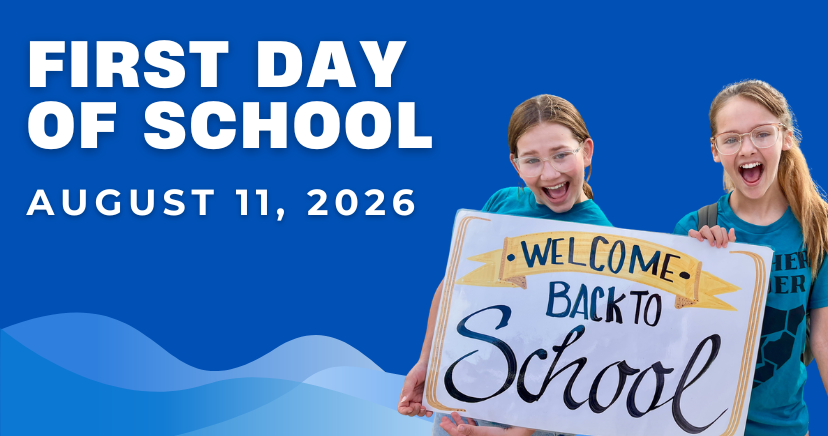 two girls smiling holding a sign that says "welcome back to school"