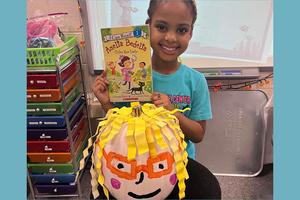 Skye Greenhowe with her book, Amelia Bedelia Tries Her Luck