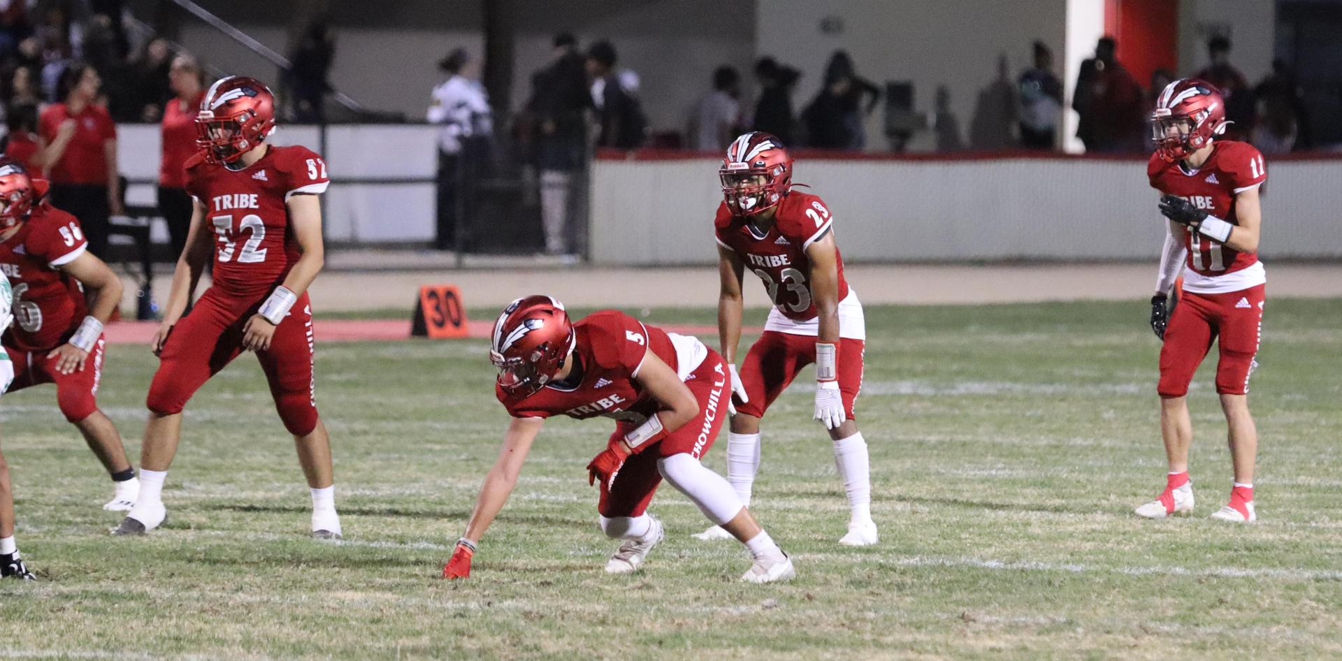 varsity football players in action against Riverdale