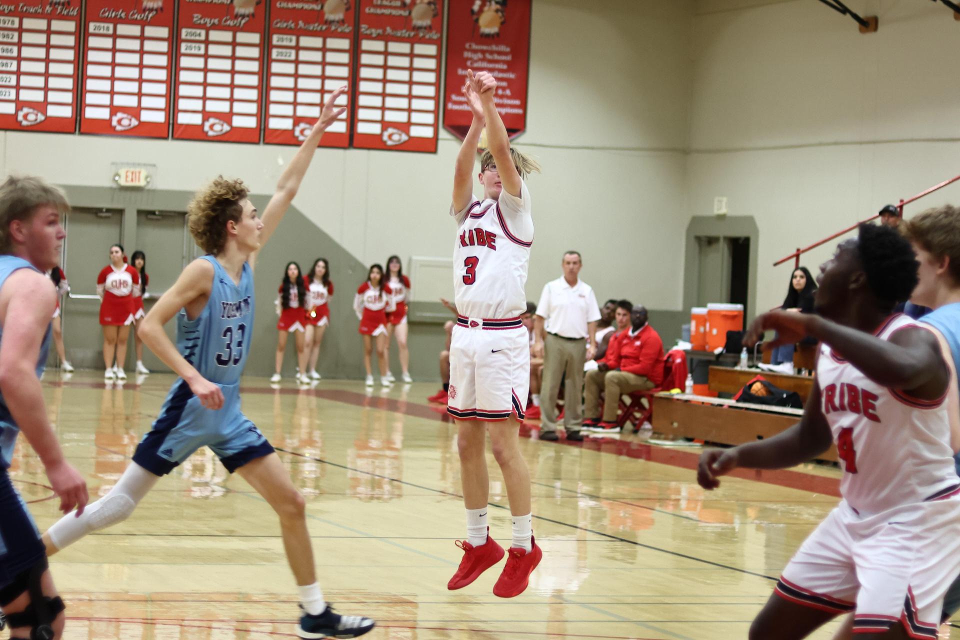 Varsity boys playing basketball against yosemite