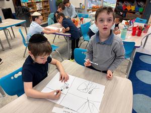 Two boys working together on their fire safety poster!