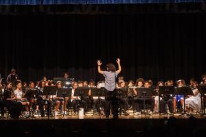 Ms Hertrick conducts the band