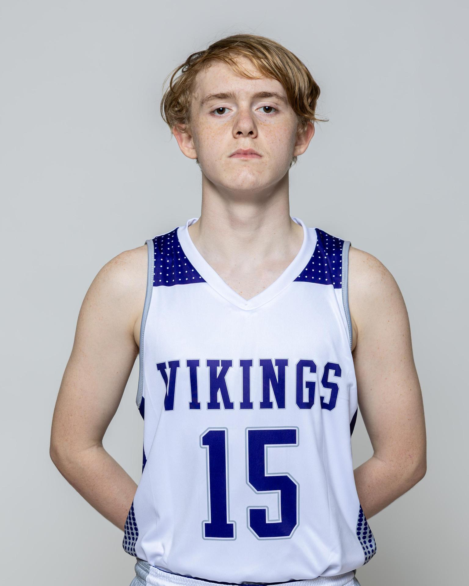 Male player number 15 posing with serious stature for a picture