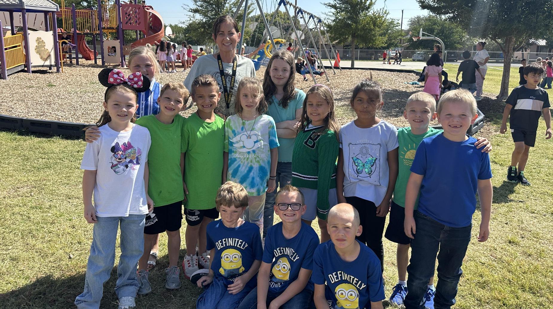 Mrs. Gutierrez smiling with students at the park