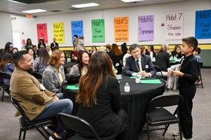 A student presents their academic and leadership goals from their Leadership Notebook to attendees.
