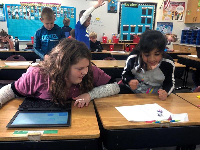 two girls coding robot