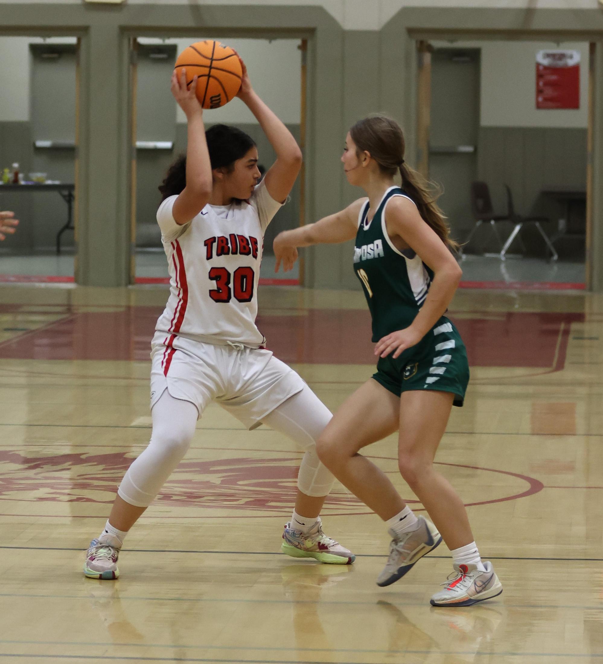 varsity girls playing basketball against mariposa