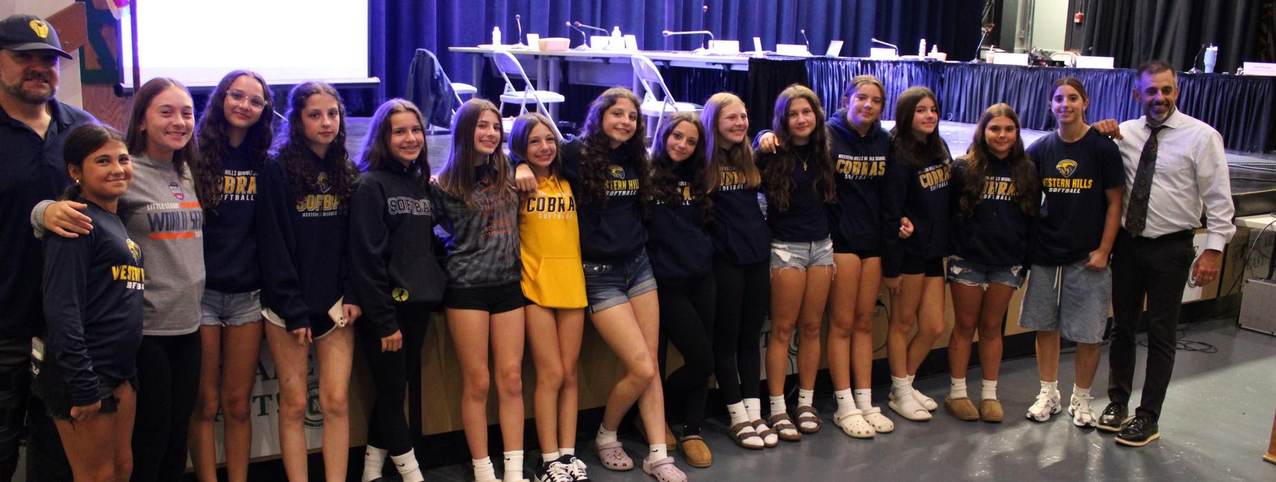 WHMS softball team and principal Tim Vesey pose along with the team coach at the school committee meeting.