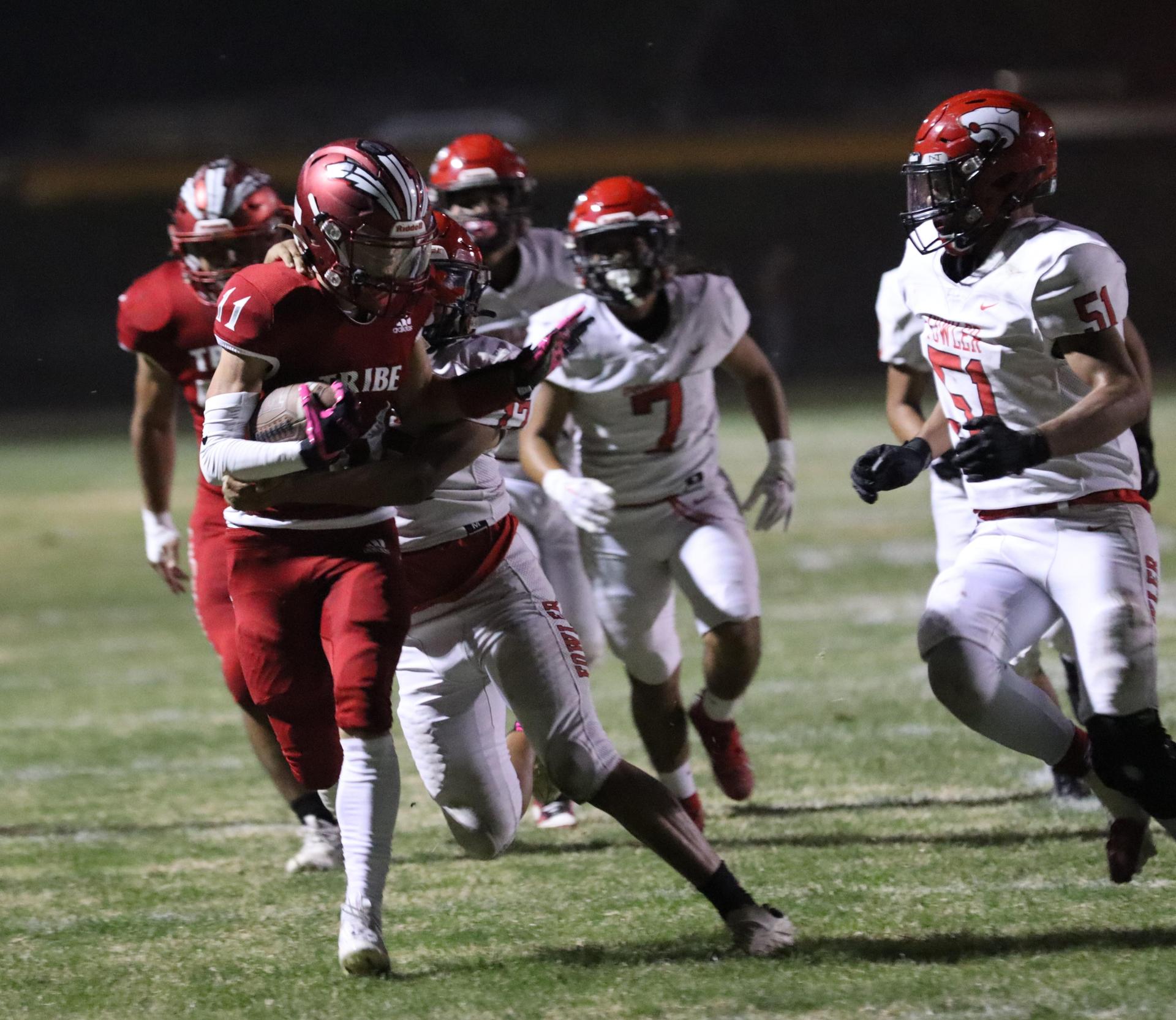varsity boys playing football against Fowler