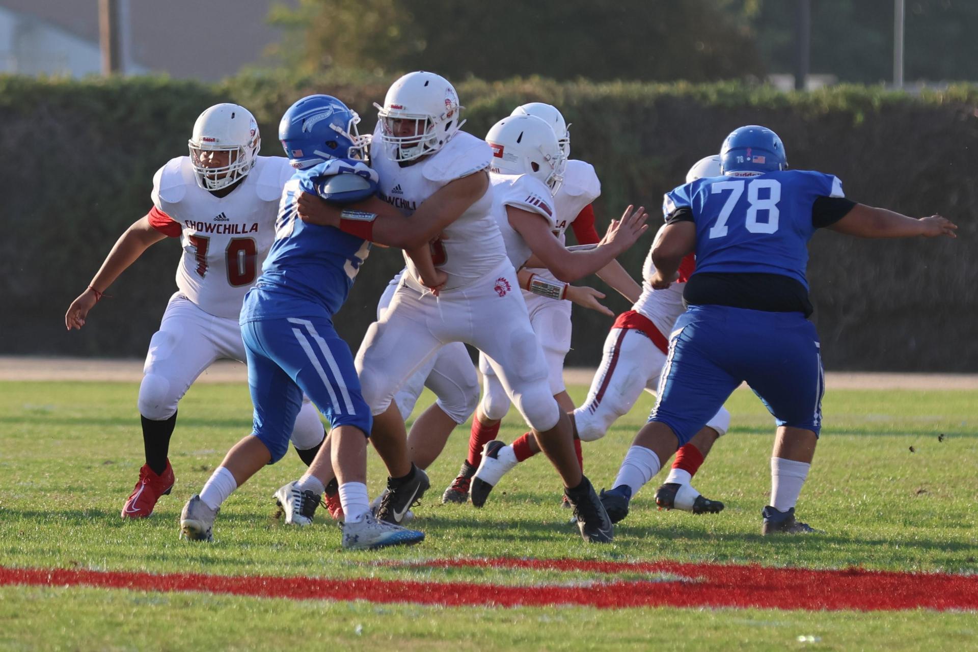 Junior Varsity football players in action against Caruthers