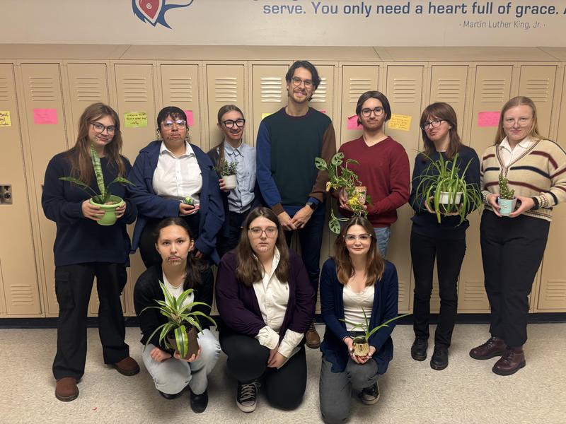 teacher and his students in front of lockers