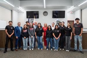 CSBA leaders and district administrators pose with Granite Hills High School students inside the school's Justice Center courtroom.