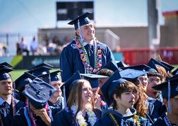 Student standing at graduation