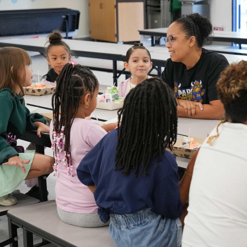 Principal Harris with students at the Student of the Month Breakfast