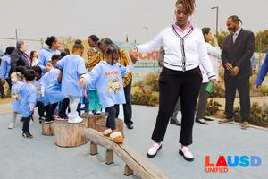 child and teacher on the balance beam