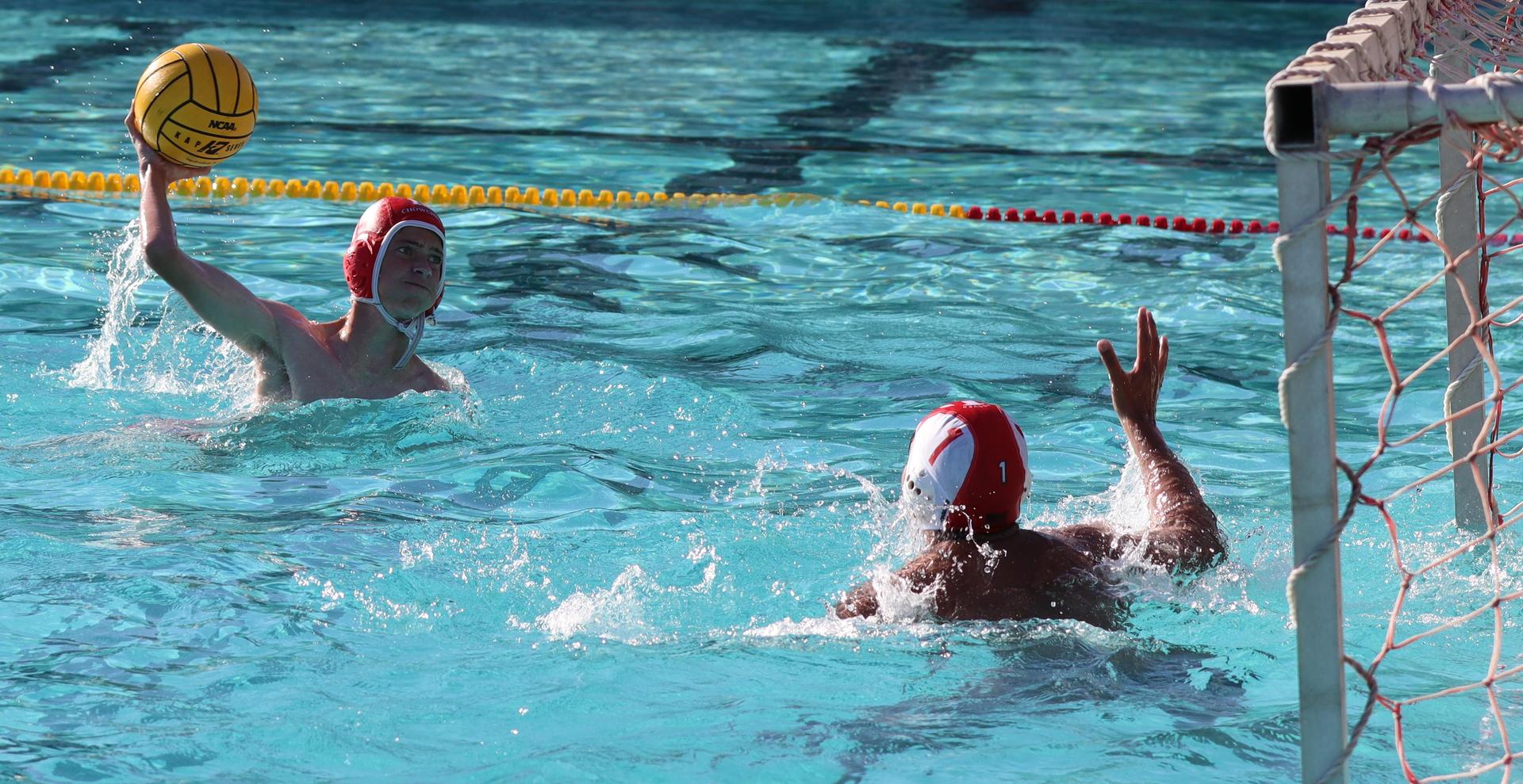 boys water polo players in action against hoover