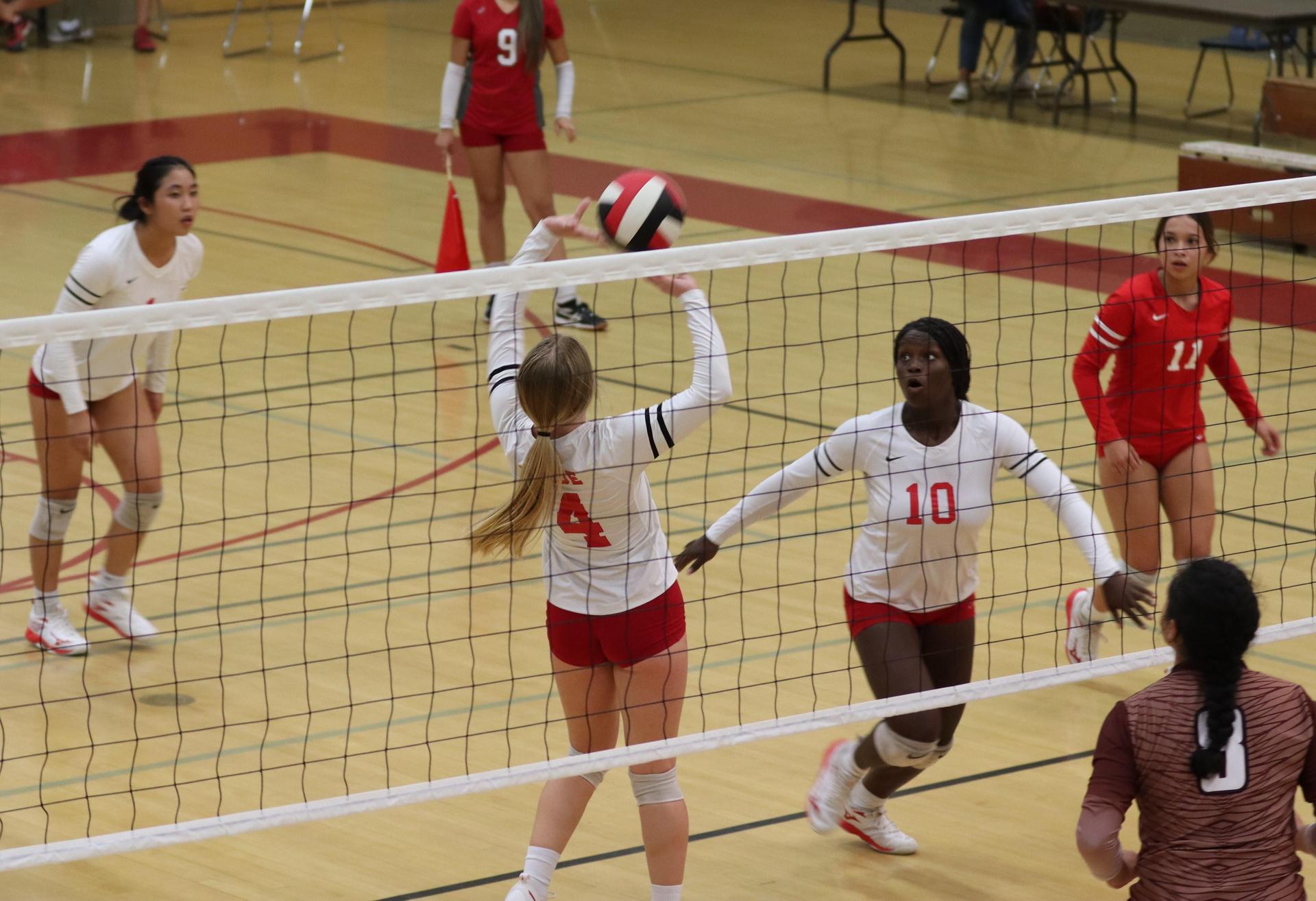 varsity volleyball players in action against Fresno Christian