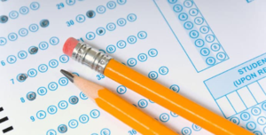 A blue bubble sheet test with two yellow pencils resting on it