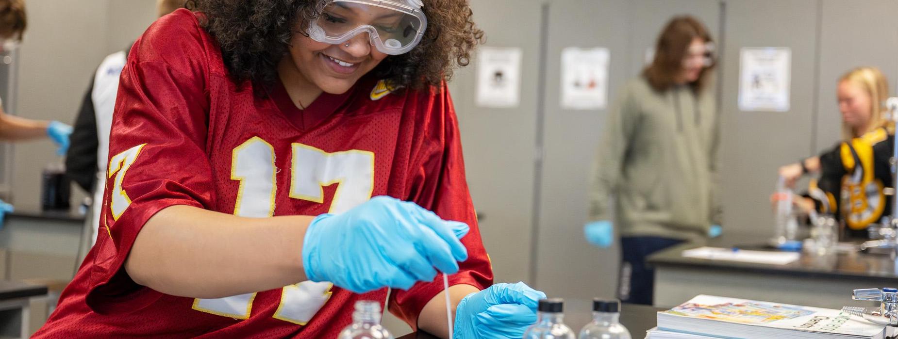 high school student performing a chemistry experiment