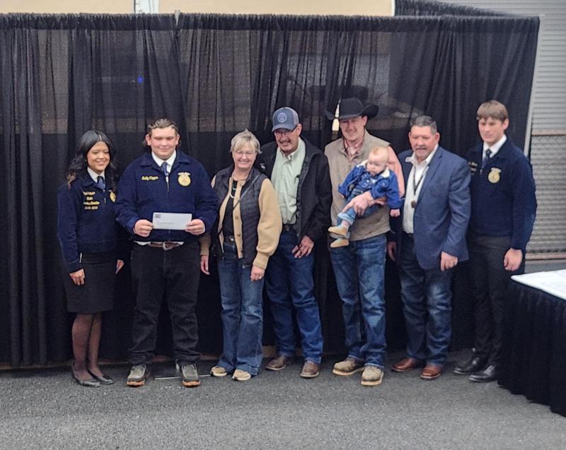 Reilly Clapper standing with supporters from Colorado FFA Foundation.