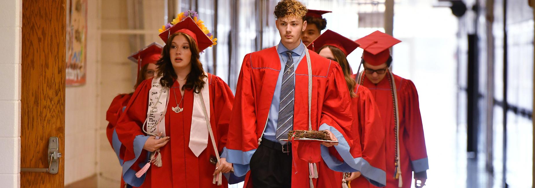 Graduates walking the hall.