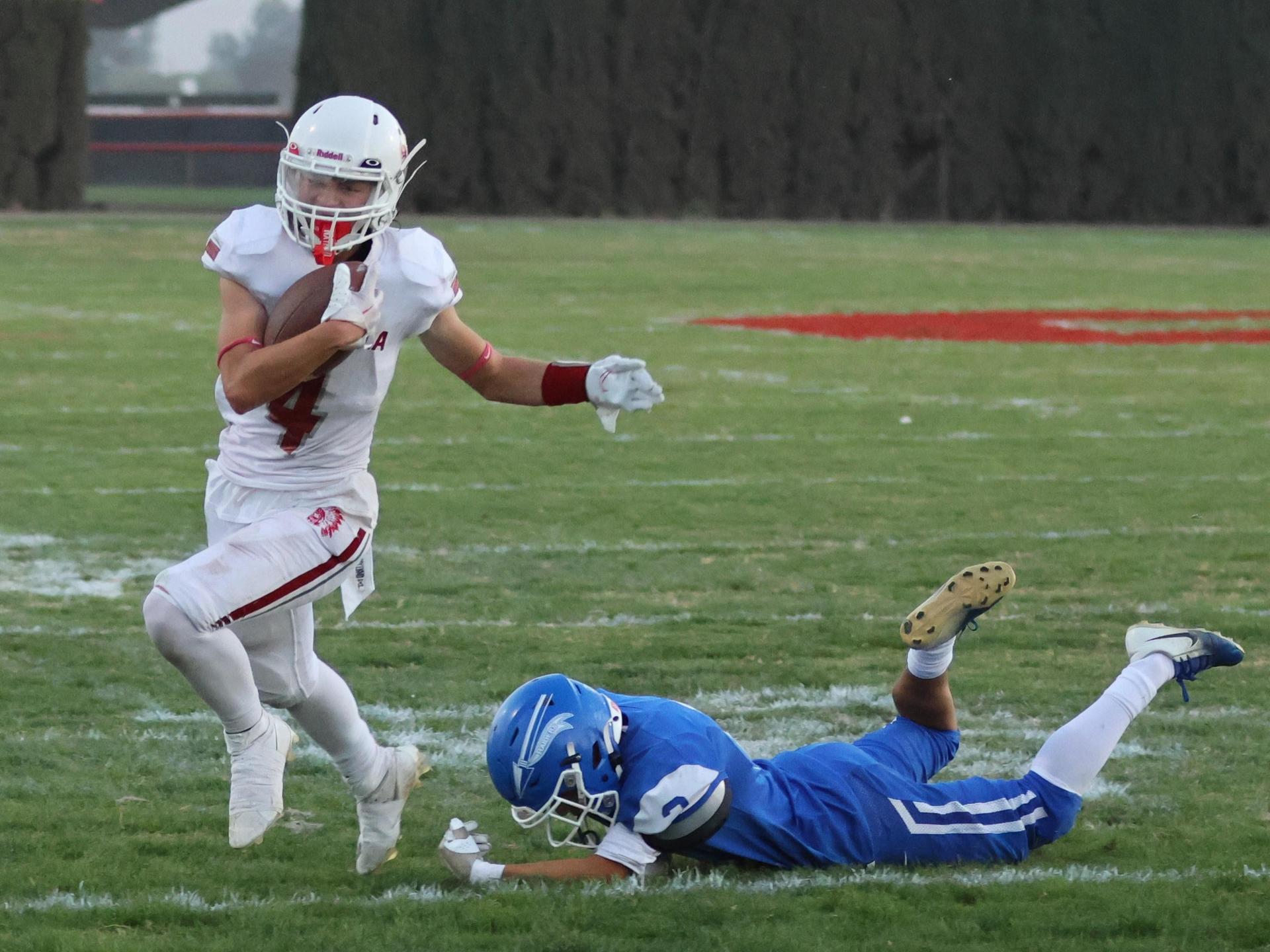 Junior Varsity football players in action against Caruthers