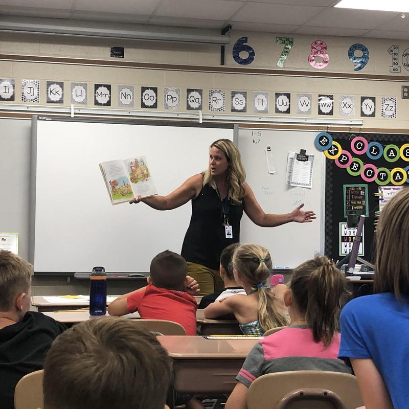 Mrs. Engbers reads the book to her students.