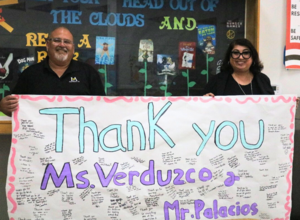 Left to right: Sierra Vista Middle School Counselors Martin Palacios and Maribel Verduzco take a group photo with a recognition banner.