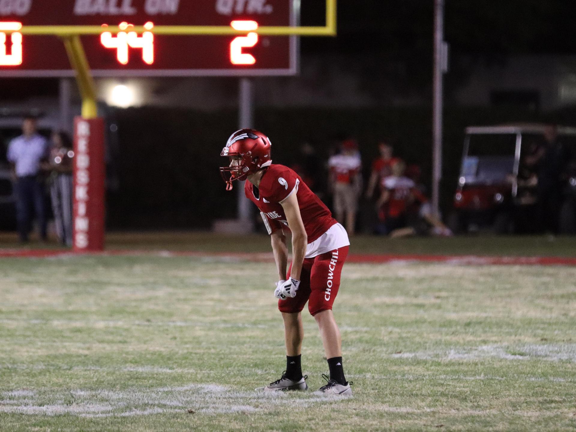 varsity football players in action against Riverdale