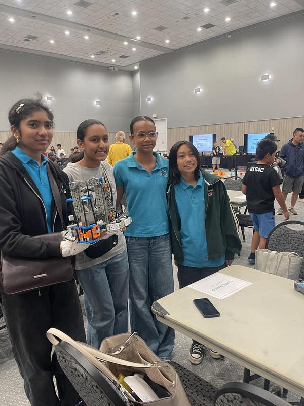 4 kids in OPA clothes holding their robots