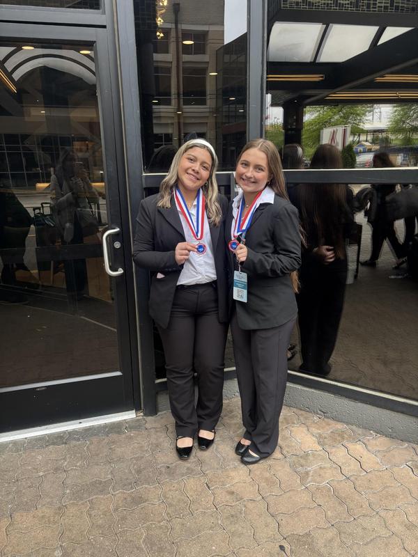 Smiling teens dressed in professional attire