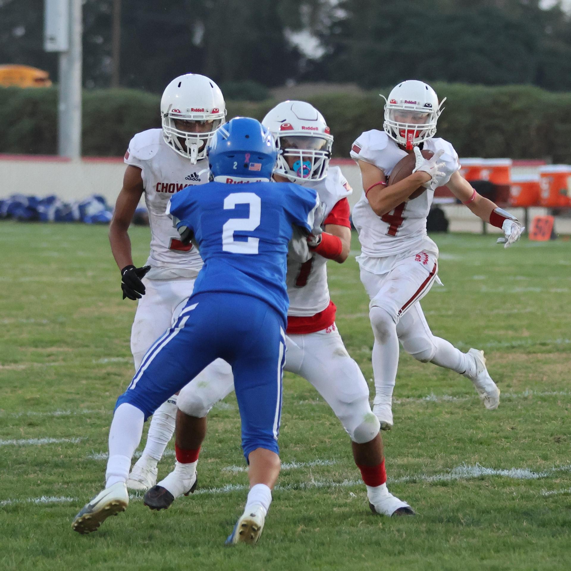 Junior Varsity football players in action against Caruthers